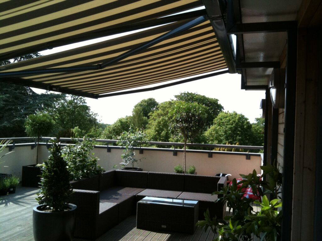 Garden seating area protected by awning in Newmarket