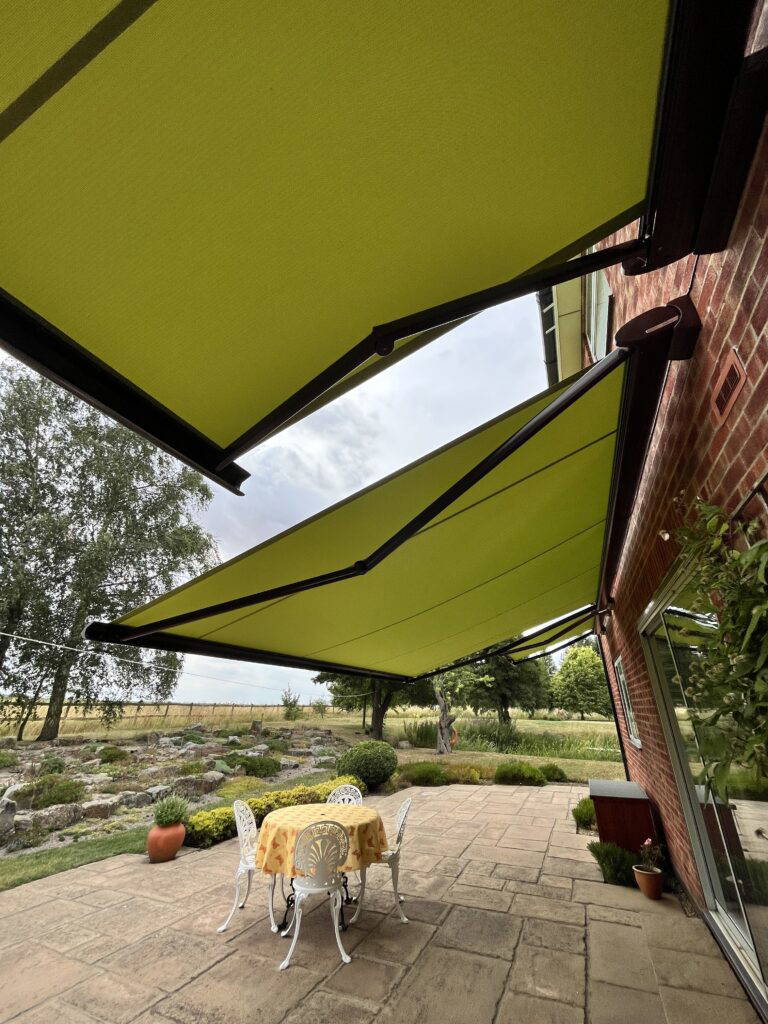 Two Weinor Cassita II awnings fitted to a house overlooking open countryside