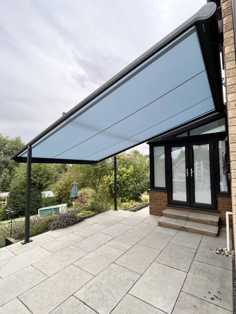 Weinor Plaza Viva pergola awning with side zip screen, viewed from the garden