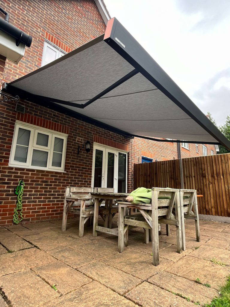 Weinor Smaila awning above a wooden garden dining table