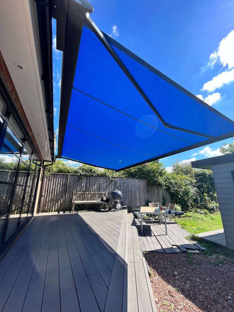 Weinor Cassita II awning above a decked garden with barbecue and seating